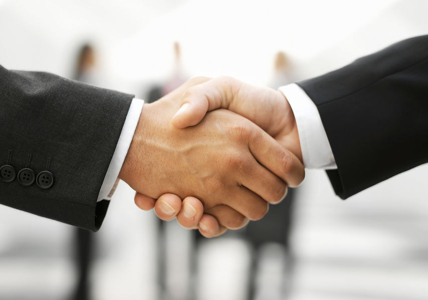 Business partnership handshake